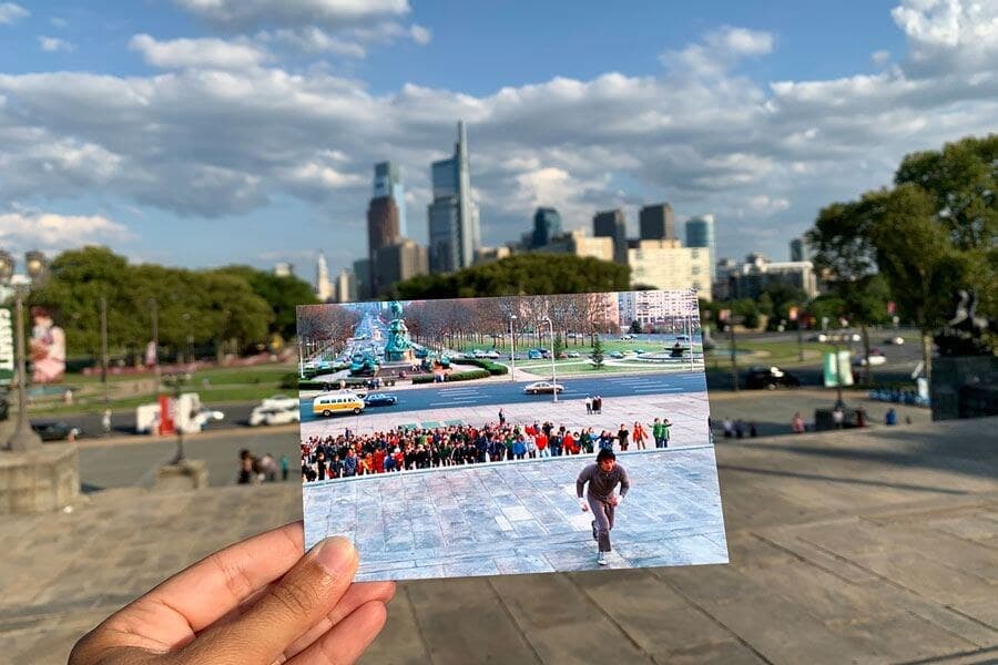 A photo of the Rocky steps scene held up at the Philadelphia Museum of Art